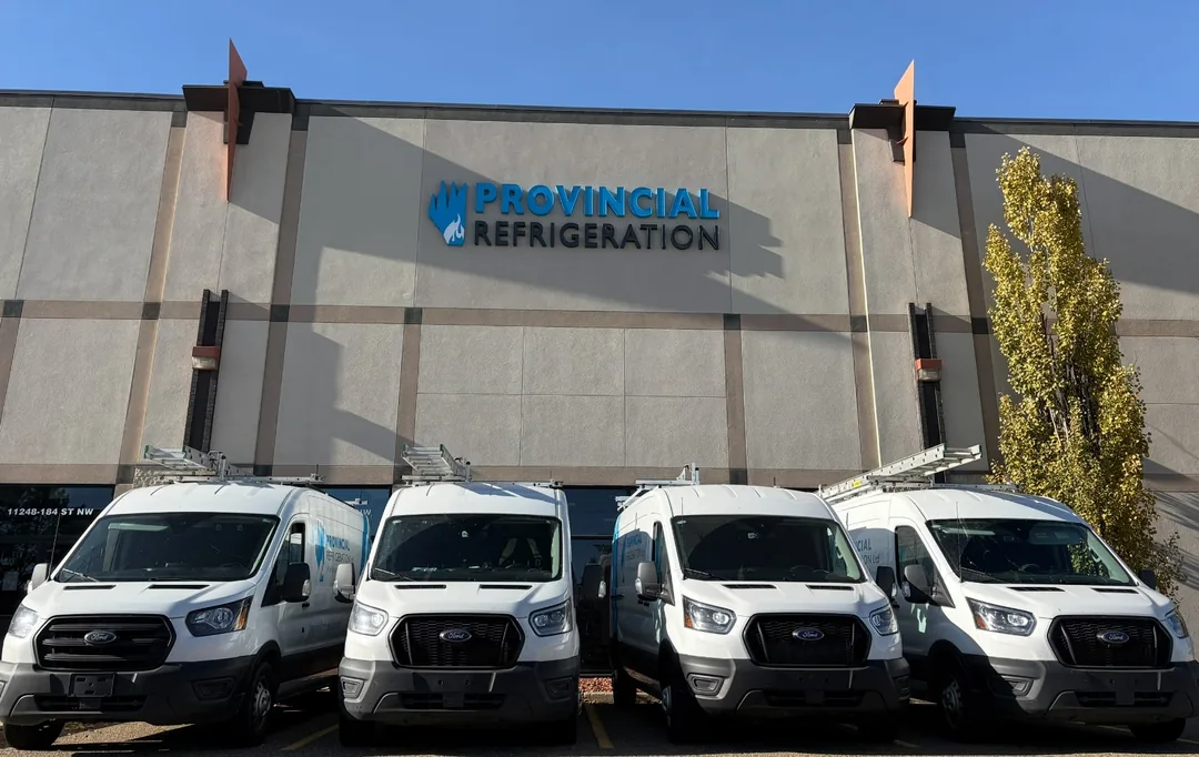 Provincial Refrigeration service vans parked outside a client building